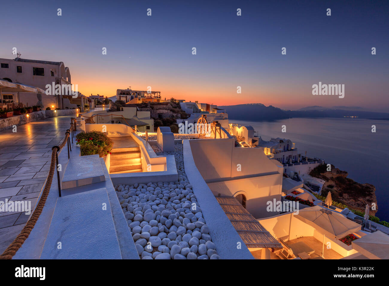 The dusk lights illuminate the typical greek village of Oia Santorini Cyclades South Aegean Greece Europe Stock Photo