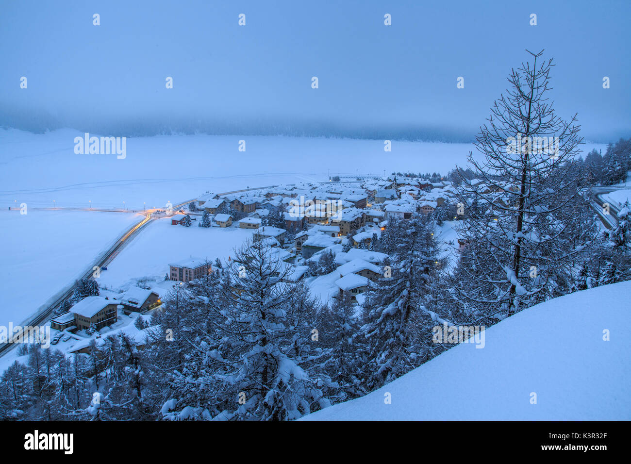 Heavy snowfall covered woods and villages Maloja Canton of Graubünden Engadine Switzerland Europe Stock Photo
