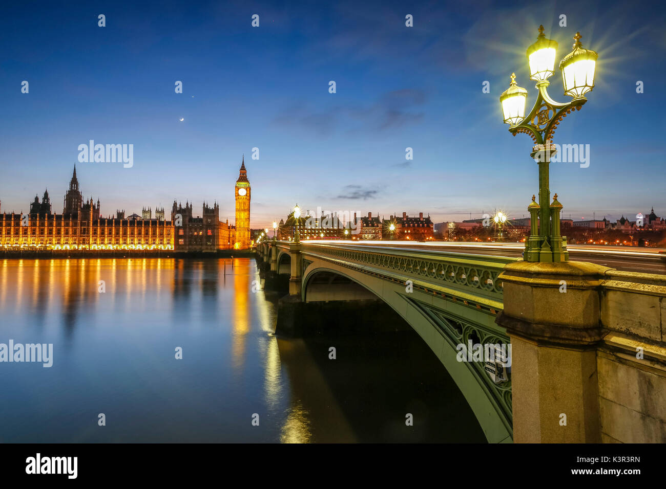 Night view of Palace of Westminster and Big Ben reflecting on Thames river. Stock Photo