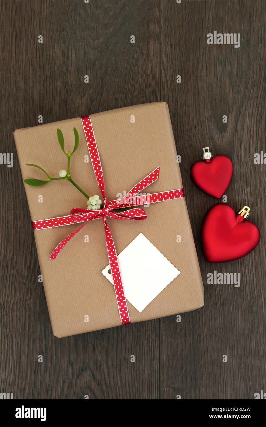 Christmas Gift Box Wrapped In Brown Paper Tag Red Ribbon With