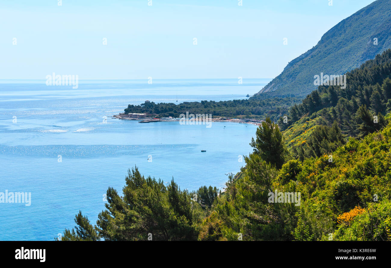 Summer Adriatic sea bay and Spiaggia Mezzavalle beach near Portonovo and Ancona towns in the Marche region. Italy, Conero Riviera. People unrecognizab Stock Photo