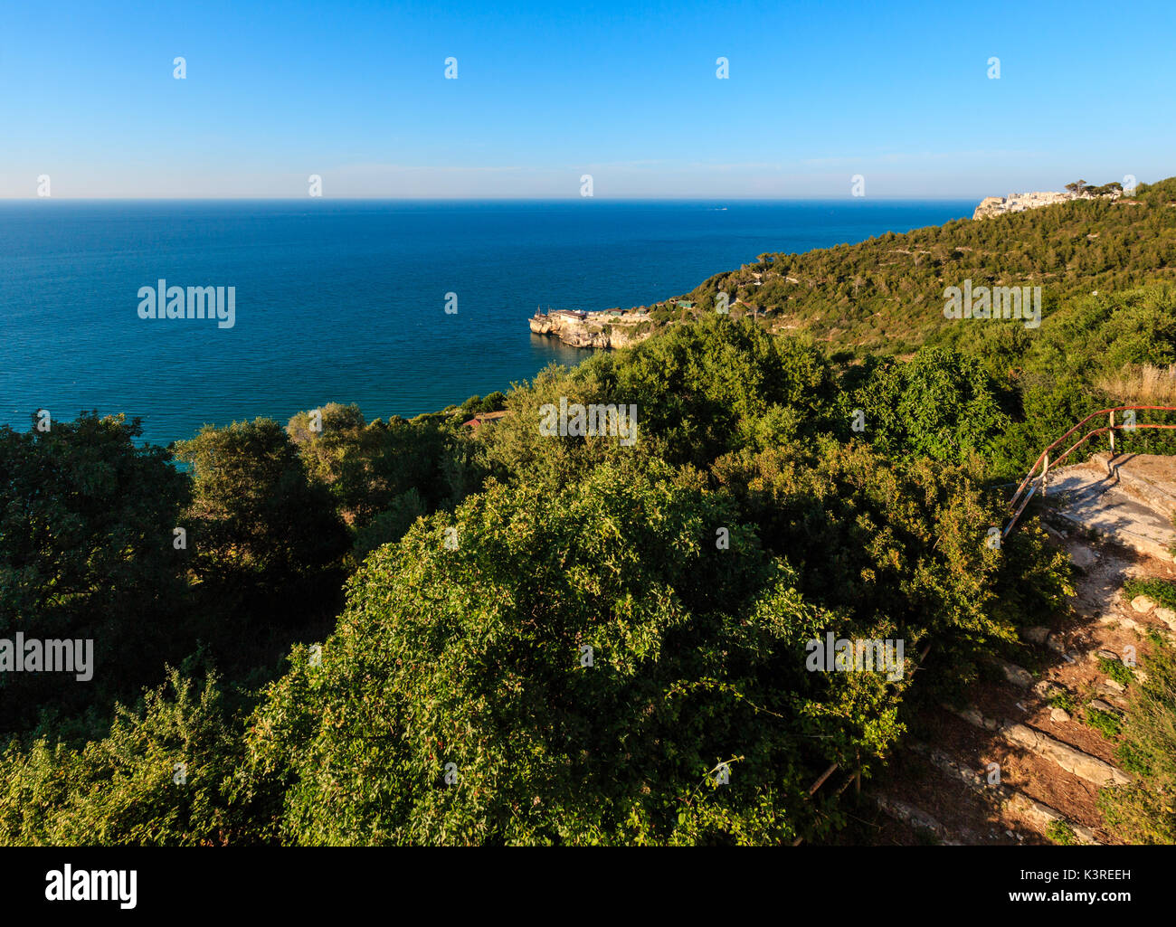 Summer sea perched Peschici town and cape Trabucco di Monte Pucci view, Gargano peninsula in Puglia, Italy Stock Photo
