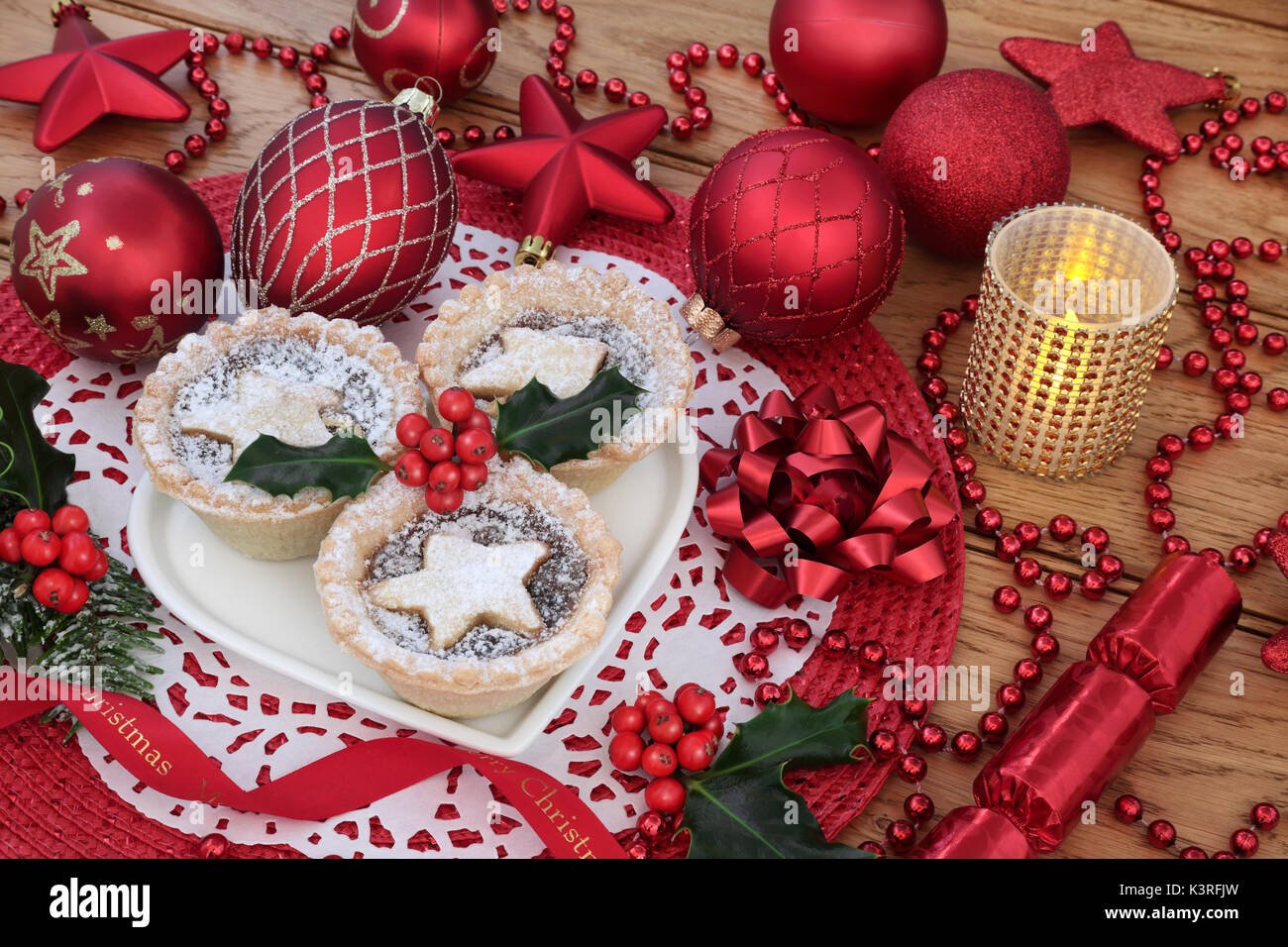 Traditional christmas iince pies on a heart shaped plate with red ...