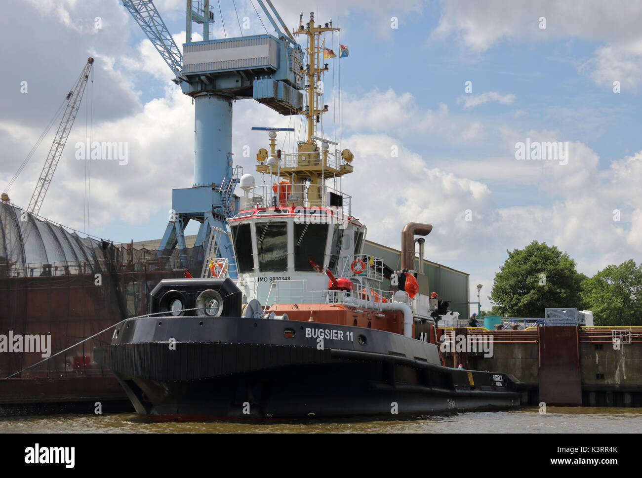 The harbor tugboat Bugsier 11 is located at the shipyard in the Port of Hamburg. Stock Photo