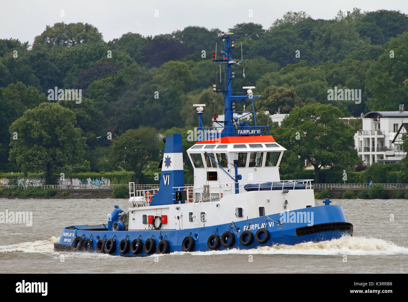 The harbor tug Fairplay VI reaches the port of Hamburg. Stock Photo