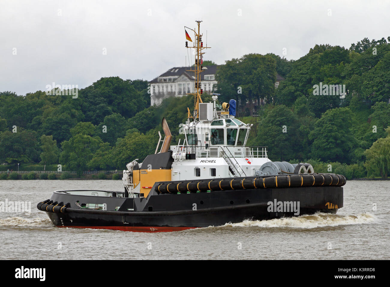 The harbor tug Michel works in the port of Hamburg. Stock Photo