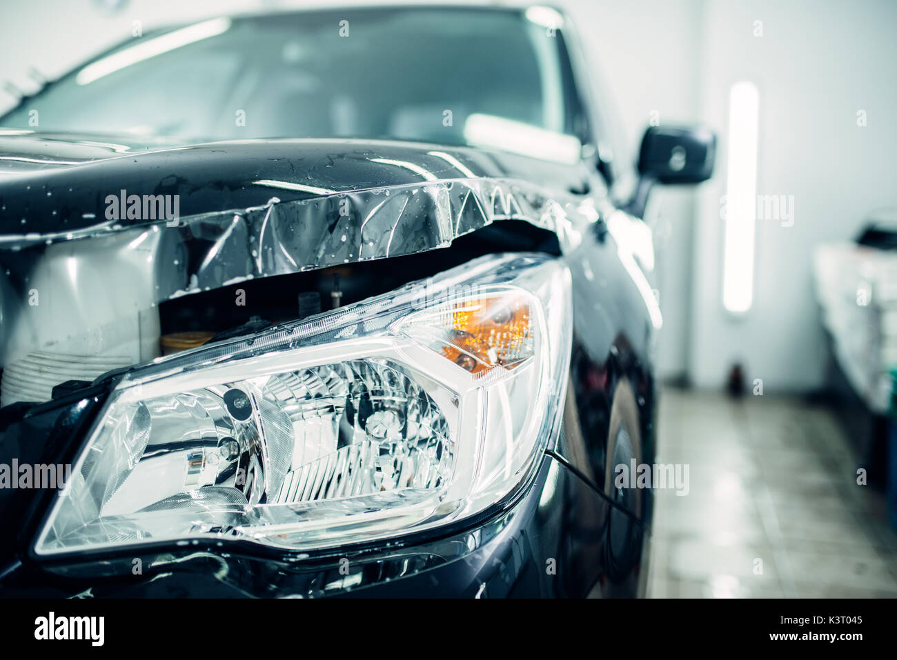 Car hood wraped in paint protection film closeup, protect against chips