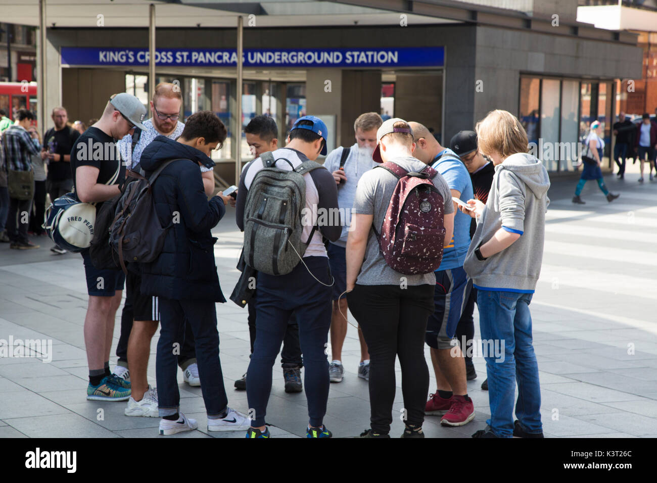 A group of people outside King's Cross St Pancras tube station