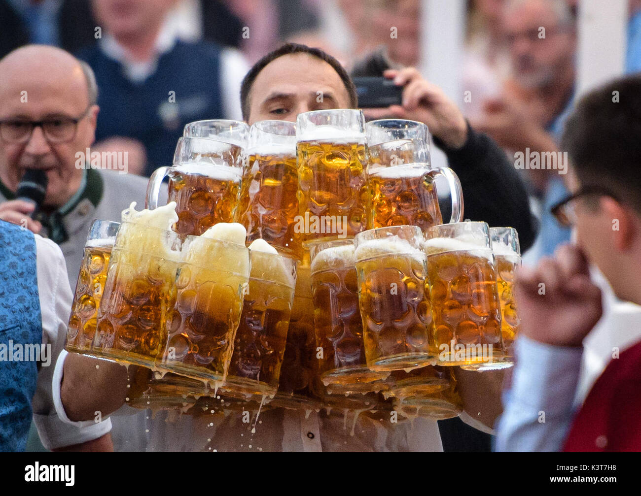 Abensberg, Germany. 03rd Sep, 2017. Oliver Struempfel carries 31 full Steins during his attempt to set a world record at a festival in Gillamoos in Abensberg, Germany, 03 September 2017. The jury accepted 29 Steins in the end - Struempfel was therefore able to break his own record. Photo: Matthias Balk/dpa/Alamy Live News Stock Photo