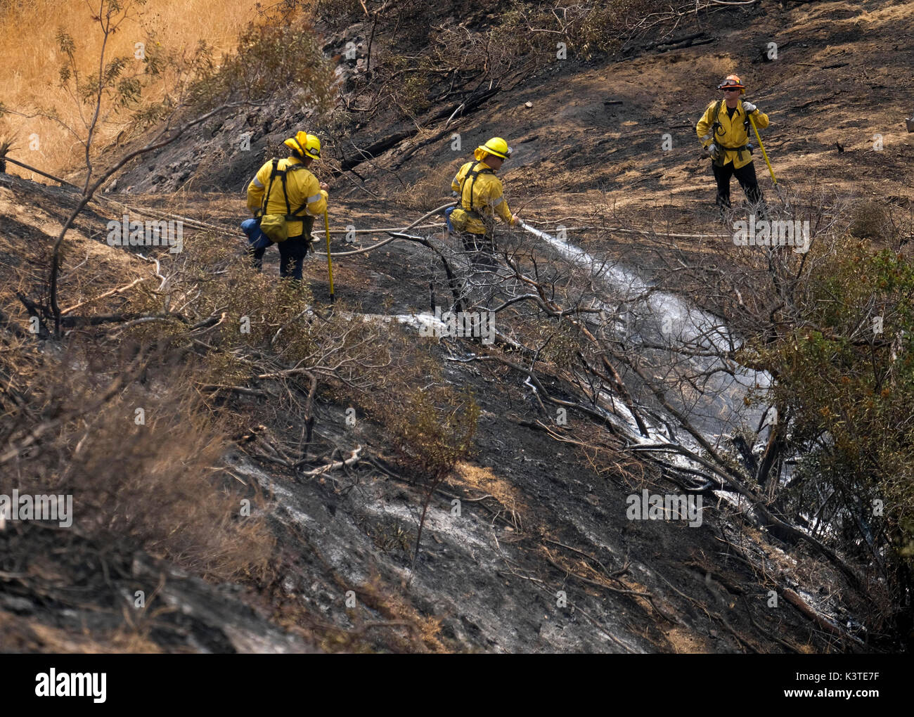 Burbank, USA. 3rd Sep, 2017. A firefighter douses the hot spots on