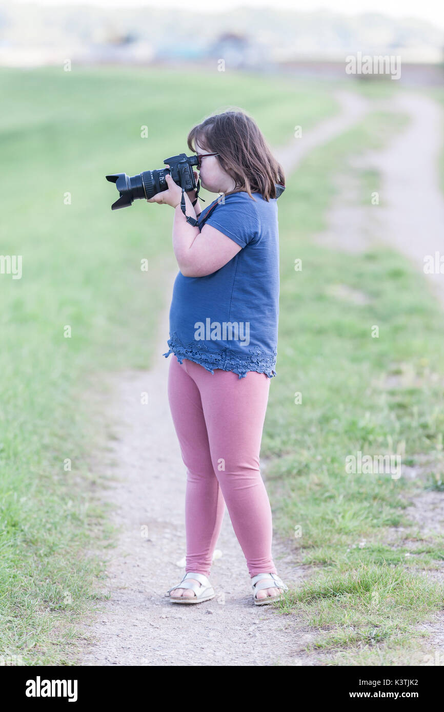 Young girl using a Canon camera. Stock Photo