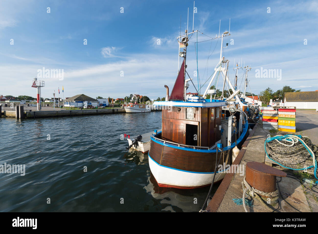 Moored timber fishing boat in the harbor of Vitte on the island Hiddensee in the morning sun, Mecklenburg-West Pomerania, Germany Stock Photo
