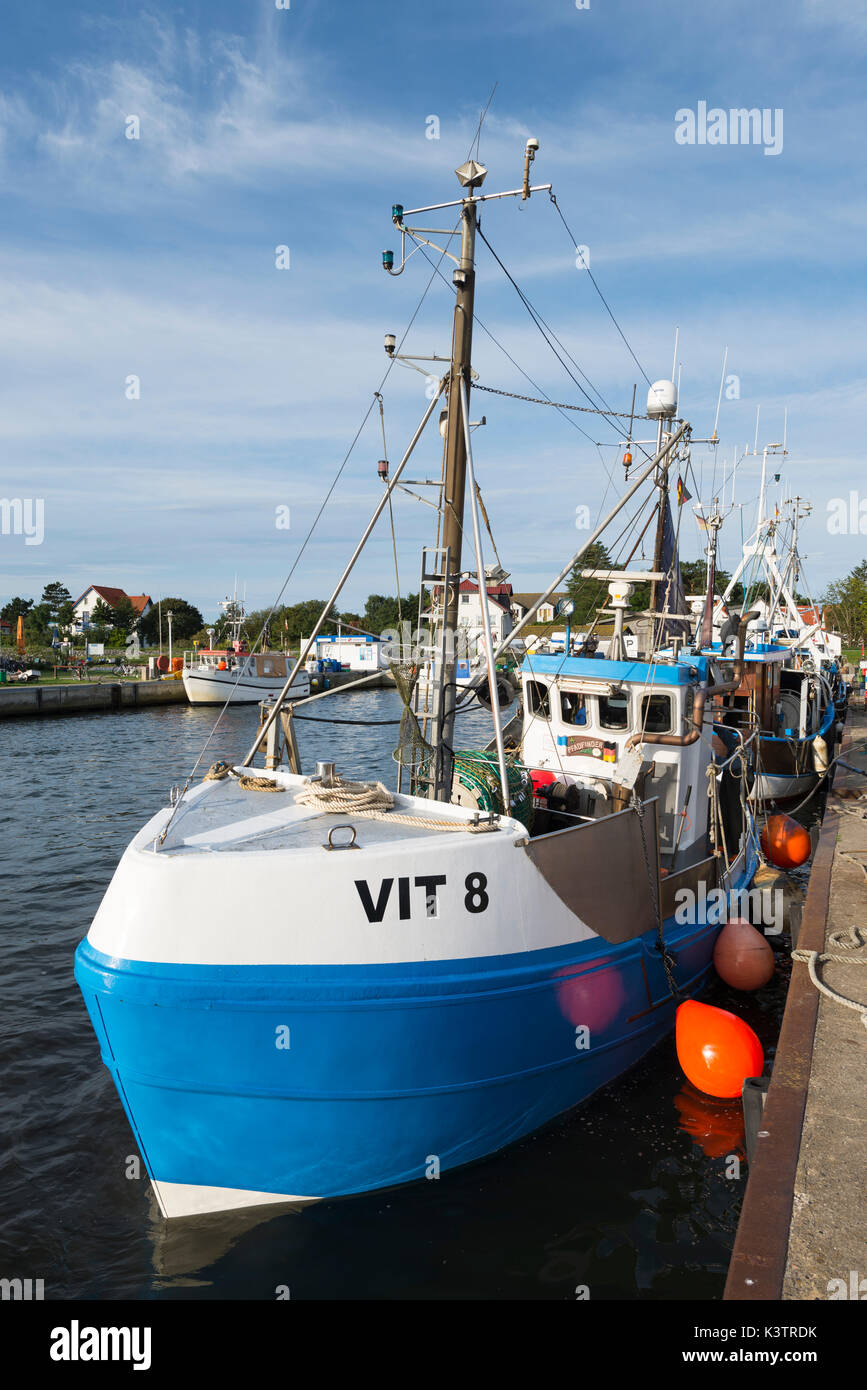 Landing fishing boat in the harbor of Vitte on the island Hiddensee returning from fishing in the morning sun, Mecklenburg-West Pomerania, Germany Stock Photo