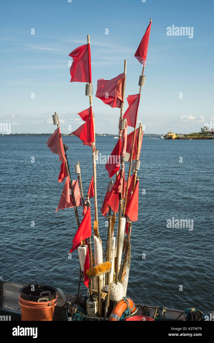 Flags and buoys for fishing nets on a fishing boat in the port of Vitte