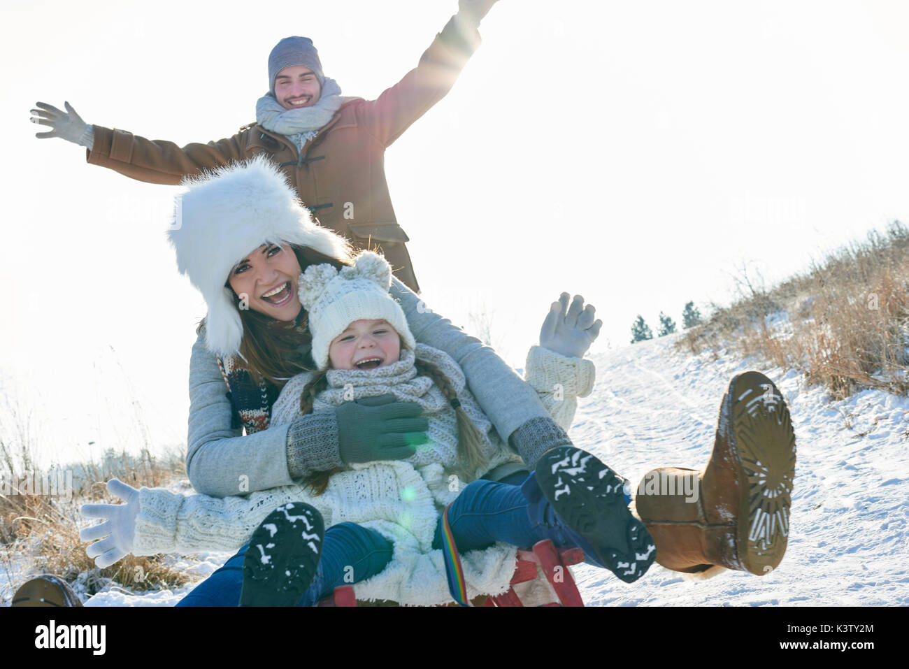 Family driving togobban in winter and having fun Stock Photo