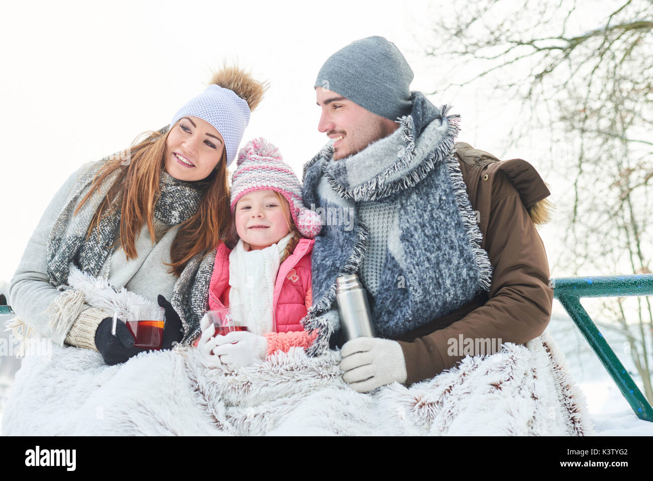 Family with child on their winter holidays sitting for relaxation Stock Photo