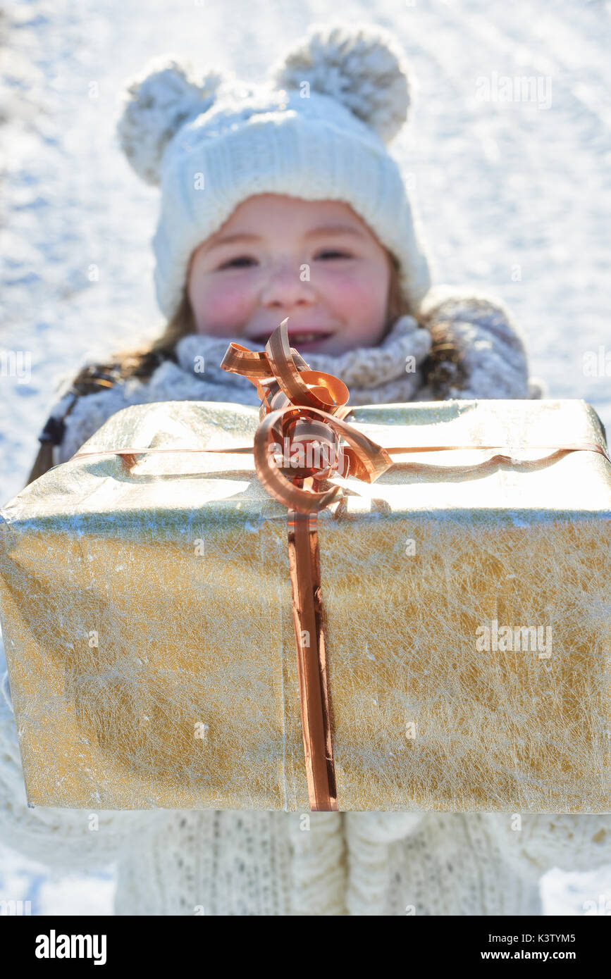 Child donates christmas gift in winter as surprise Stock Photo - Alamy