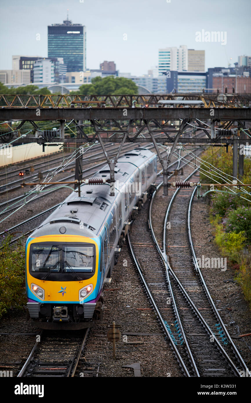TransPennine Express multiple units franchise railway line from Ardwick leading to Manchester Piccadilly  station with city skyline  West Coast Main L Stock Photo