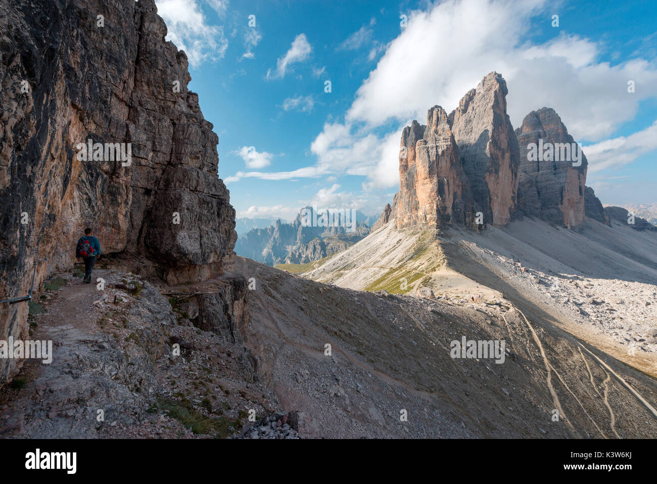 Europe, Italy, Dolomites, Veneto, Belluno. Hiker admire Tre Cime di Lavaredo from Trenches of the First World War on Mount Paterno Stock Photo
