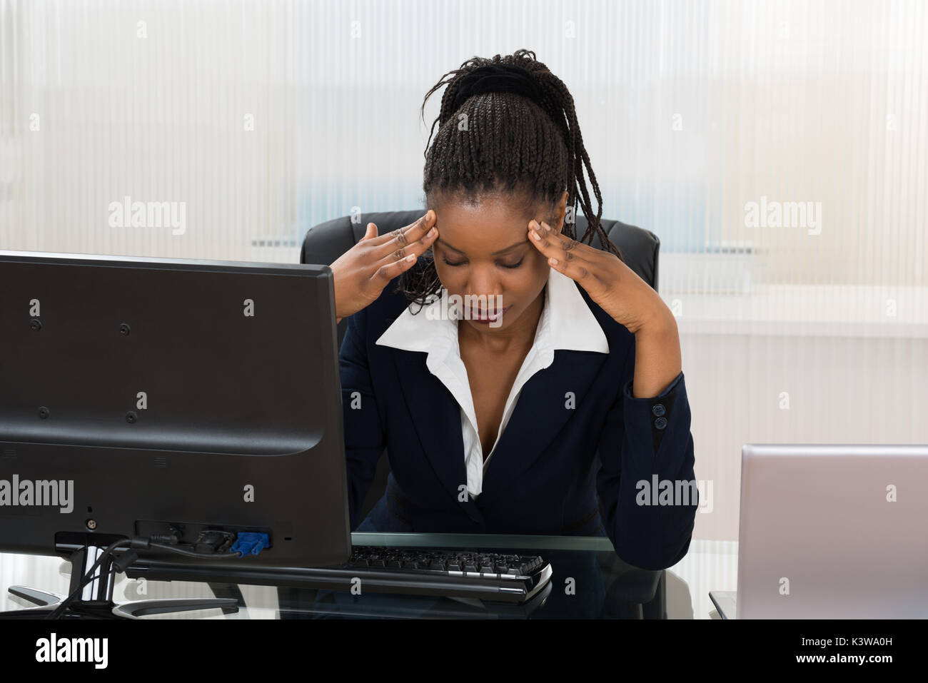 Stressed African Businesswoman Sitting At Office Desk Stock Photo - Alamy