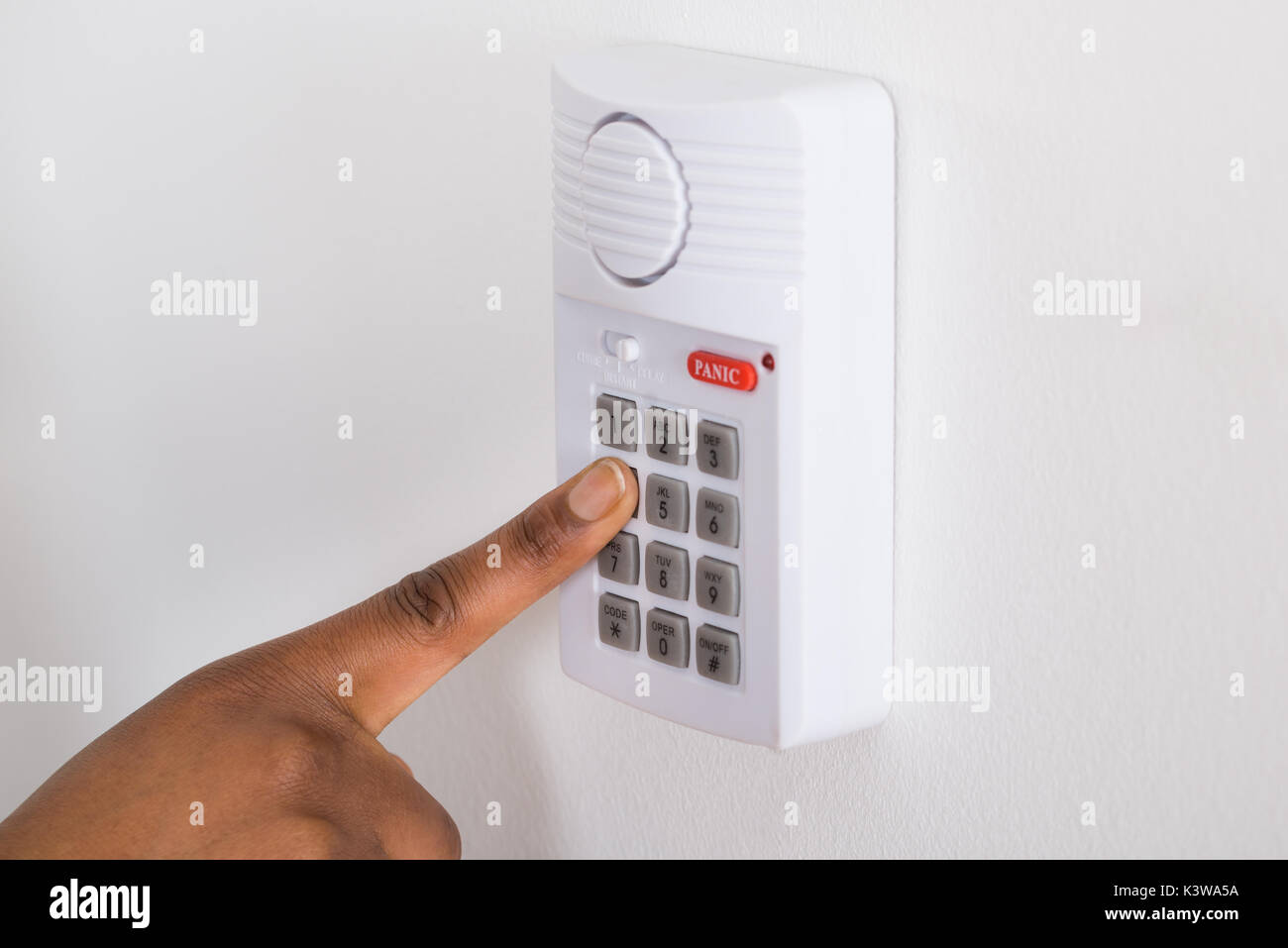 Close-up Of Person's Hand Pressing Button On Security System Stock Photo