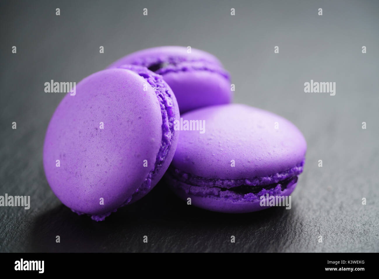 bright violet macarons on slate background Stock Photo