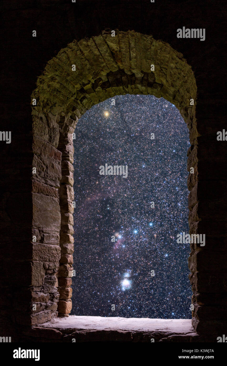 The Orion constellation visible through an old ancient stone window