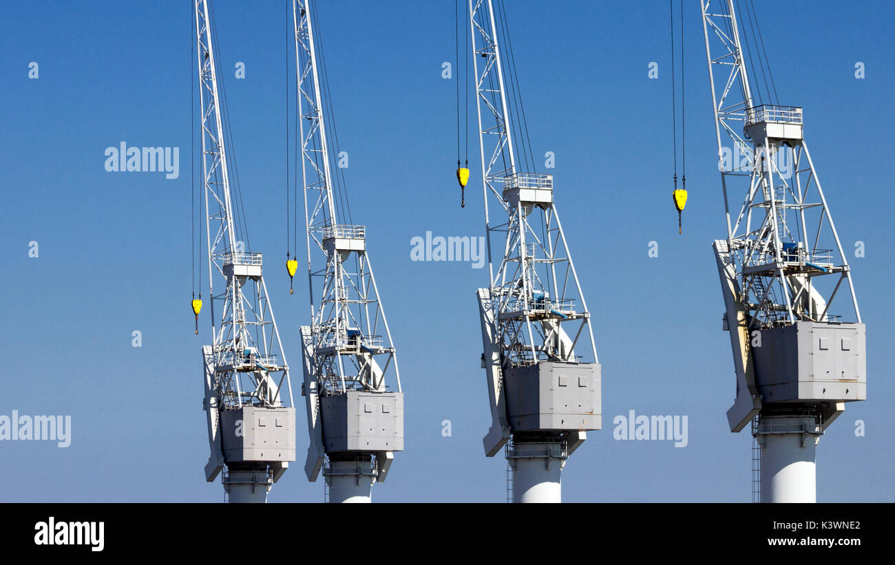 Row of harbor cranes in the Port of Antwerp. Stock Photo