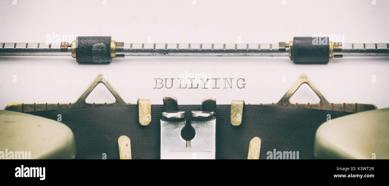 Close-up of BULLYING word on a typewriter sheet Stock Photo