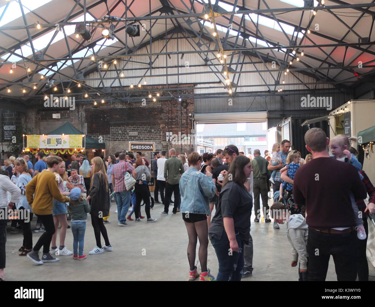 Hipsters and families attending Peddler Night Market, a popular monthly showcase for street food stalls and makers in Kelham Island, Sheffield, UK Stock Photo