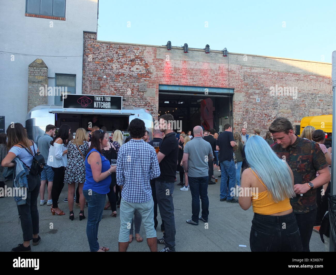 Hipsters and families attending Peddler Night Market, a popular monthly showcase for street food stalls and makers in Kelham Island, Sheffield, UK Stock Photo
