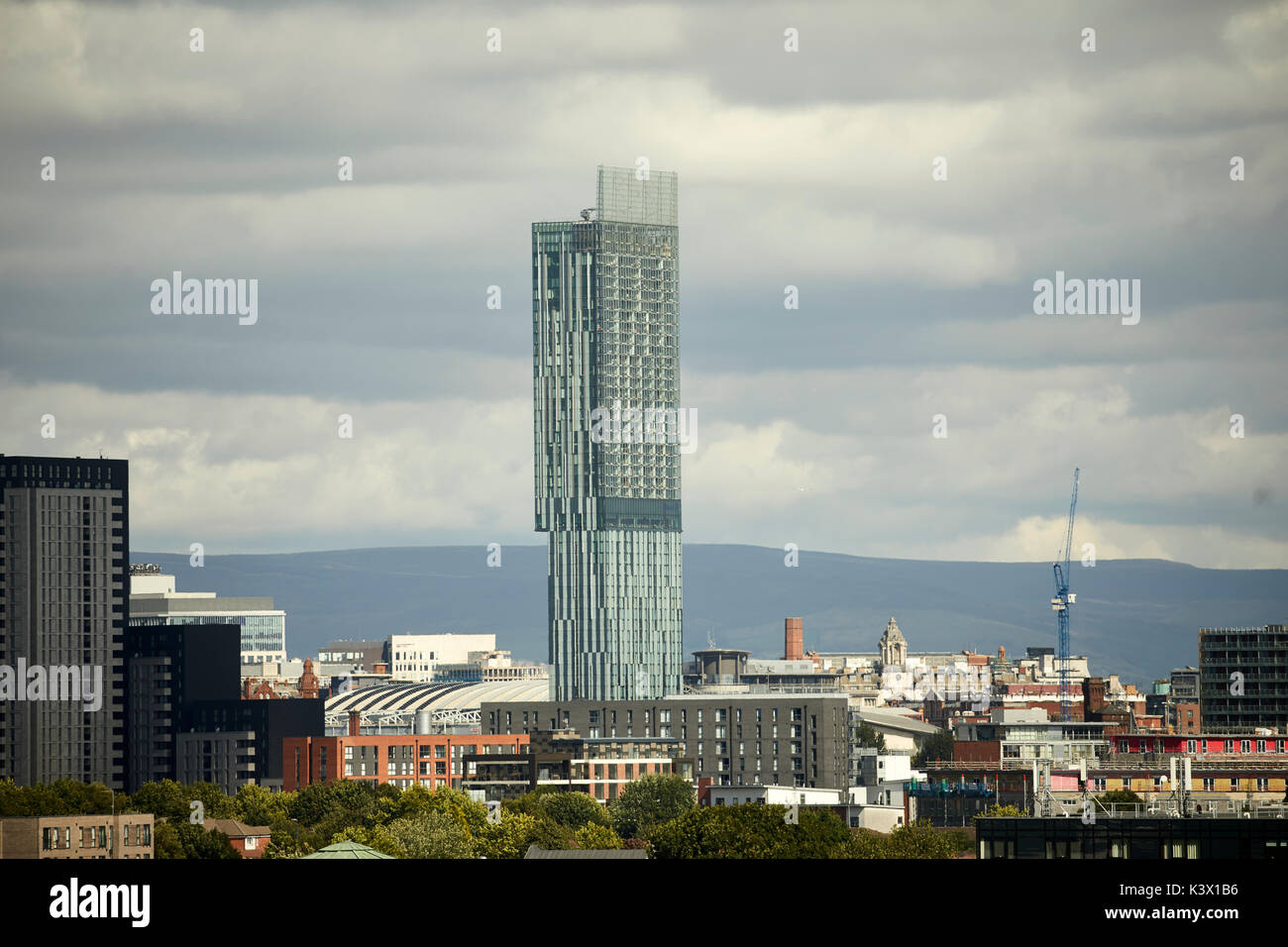 Manchester city centre skyline dominated by Beetham Tower Hilton hotel and luxury apartments and the Pennine hills behind Stock Photo