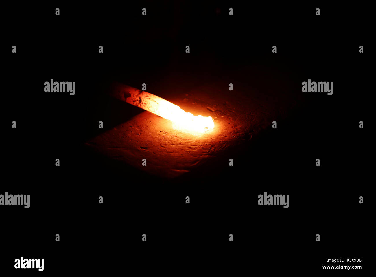 Close-up of  red hot molten iron placed on an anvil in blacksmith's workshop Stock Photo