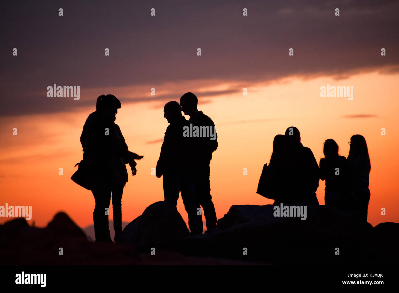 silhouettes of people at sunset Stock Photo - Alamy