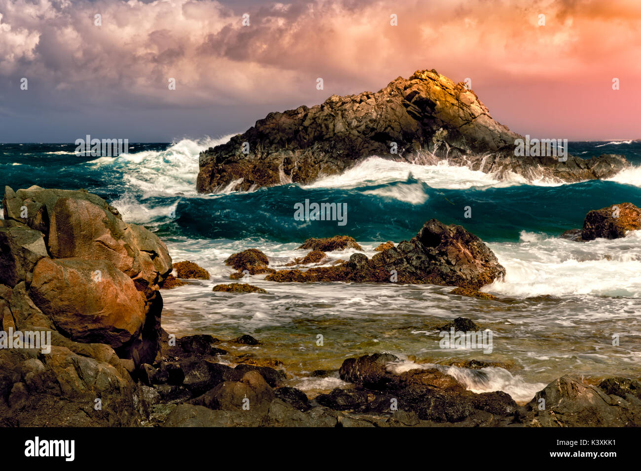 Dramatic sunset with stormy Atlantic waters in Arikok national park, Aruba. Stock Photo