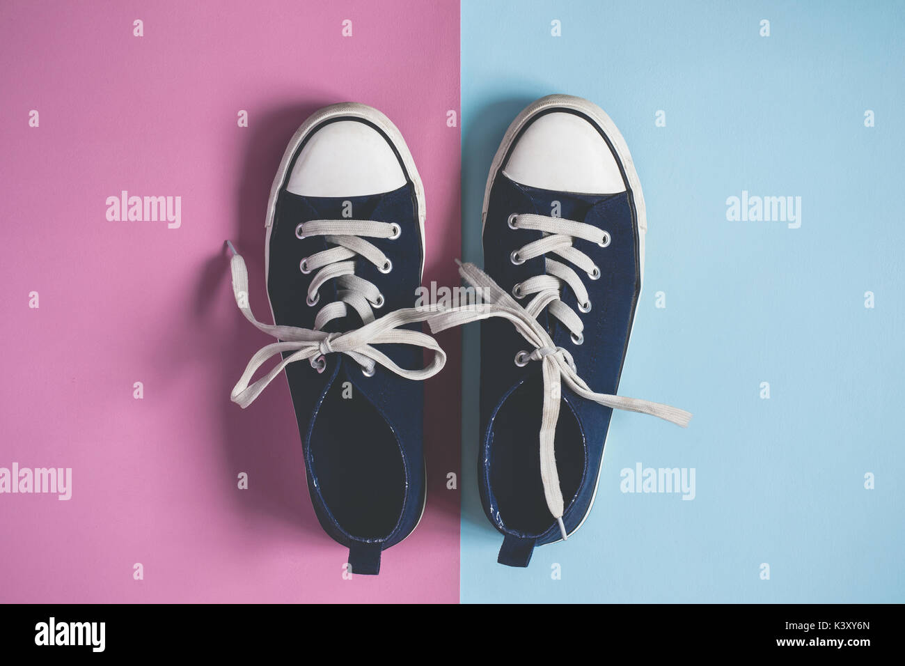 female or male Dark blue Sneakers on pink blue pastel background flat ...