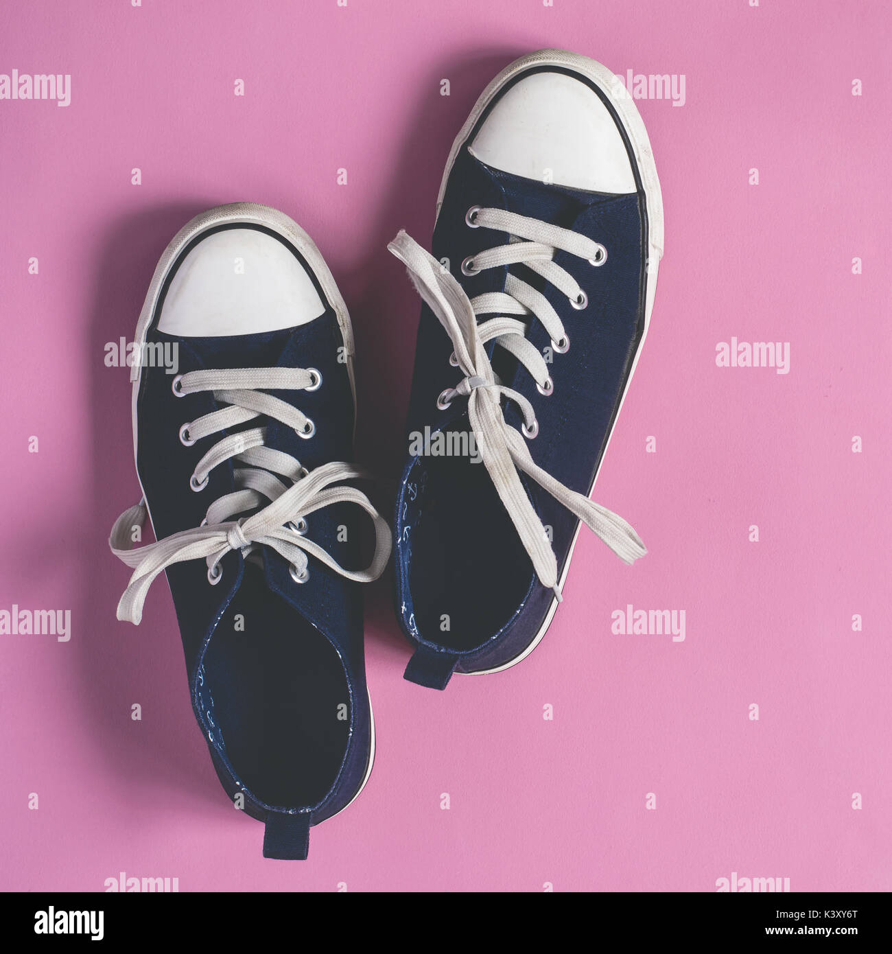 Dark blue Sneakers on pink pastel background flat lay Stock Photo - Alamy