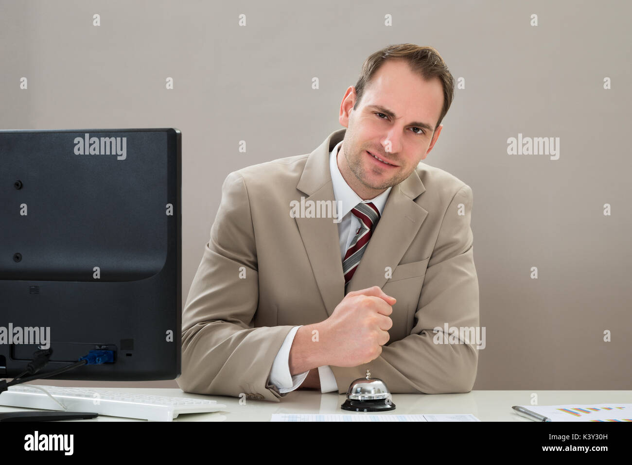 Businessman Using Service Bell At Desk In Office Stock Photo Alamy