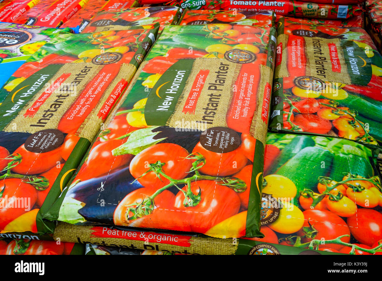 A stack of extra large New Horizon Instant Planter  grow bags in a garden centre used for growing tomato plants peppersor other similar plants Stock Photo