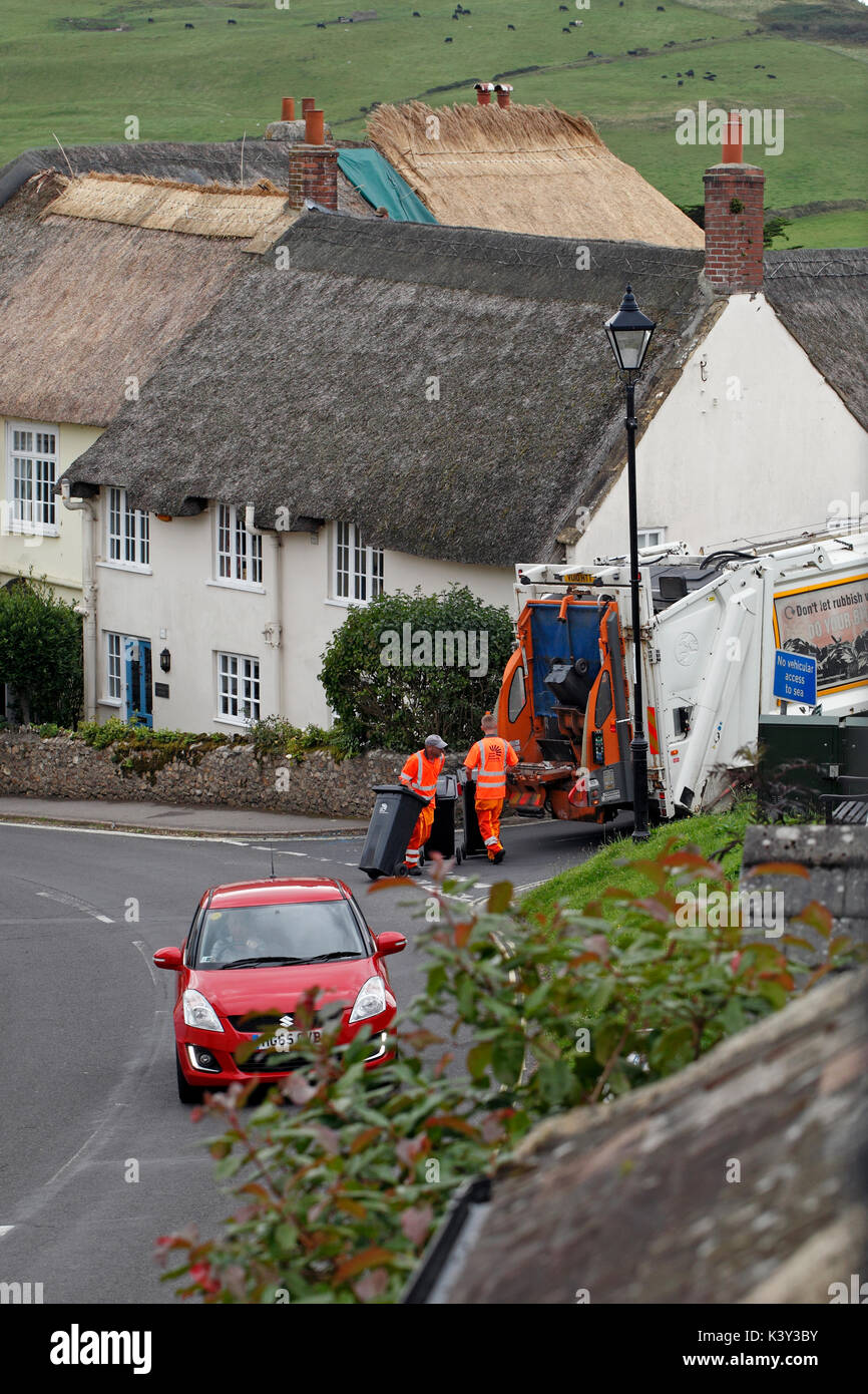 Refuse collection or bin men in a country town. Stock Photo