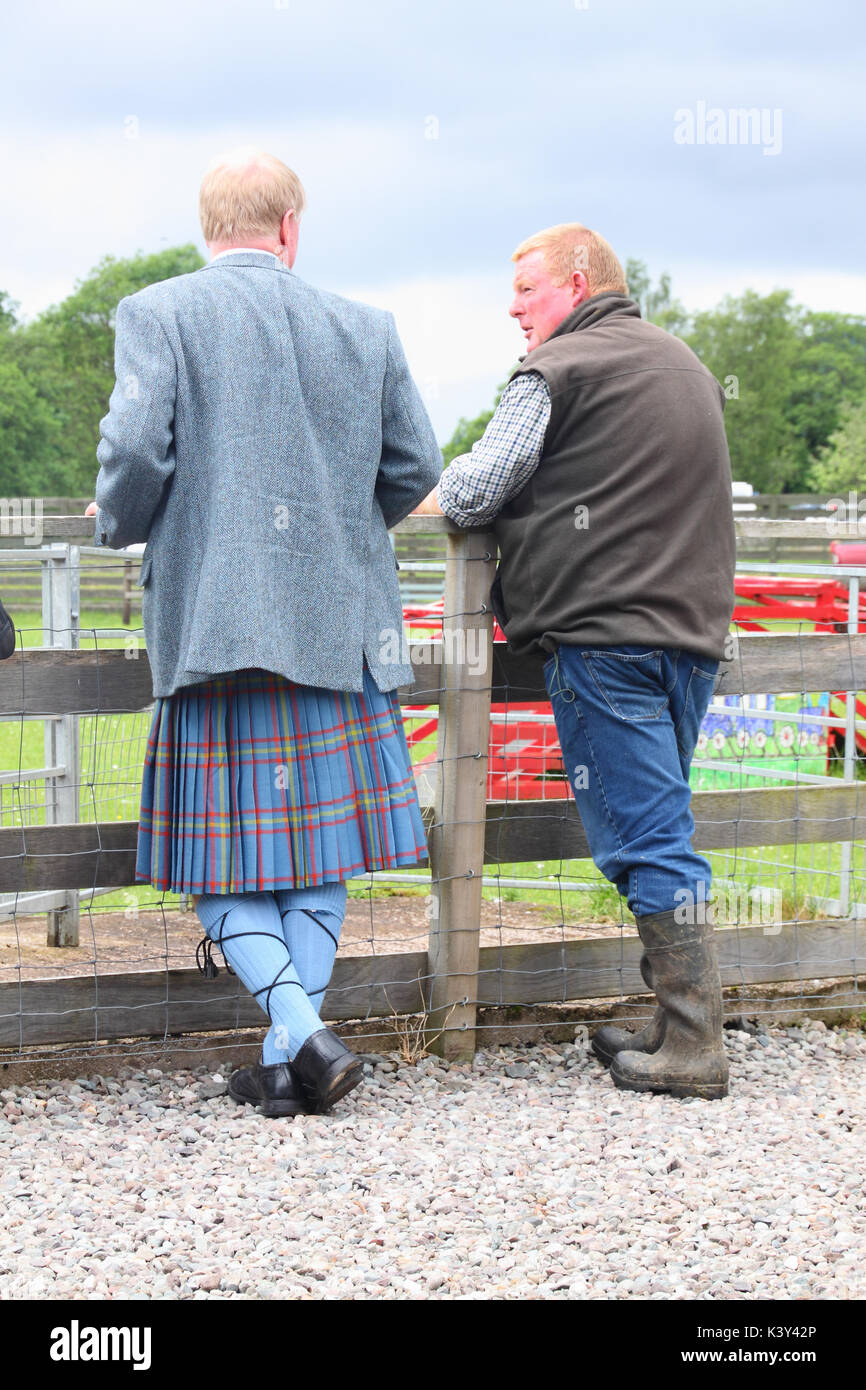 2 Scotsmen, one in traditional Scottish dress, one in working clothes, Aberfoyle, Scotland Stock Photo