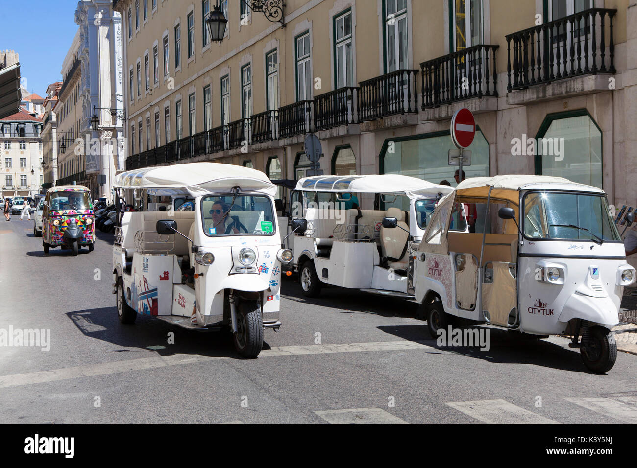 Tuk Tuks driving in Lisbon, the capital and the largest city of Portugal in the Alfama District on the Atlantic coast in Western Europe Stock Photo