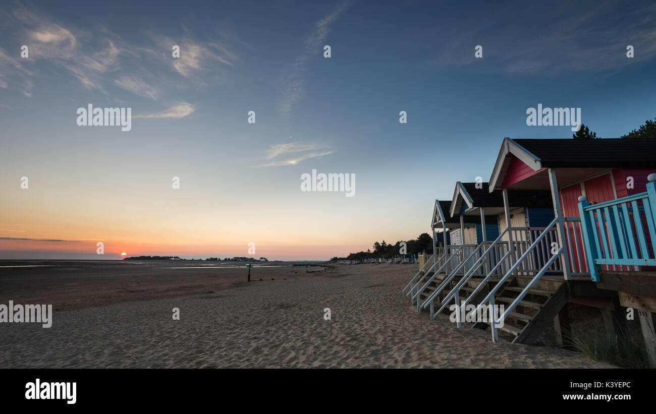 Sunrise on Wells beach with beach huts in the foreground. Stock Photo