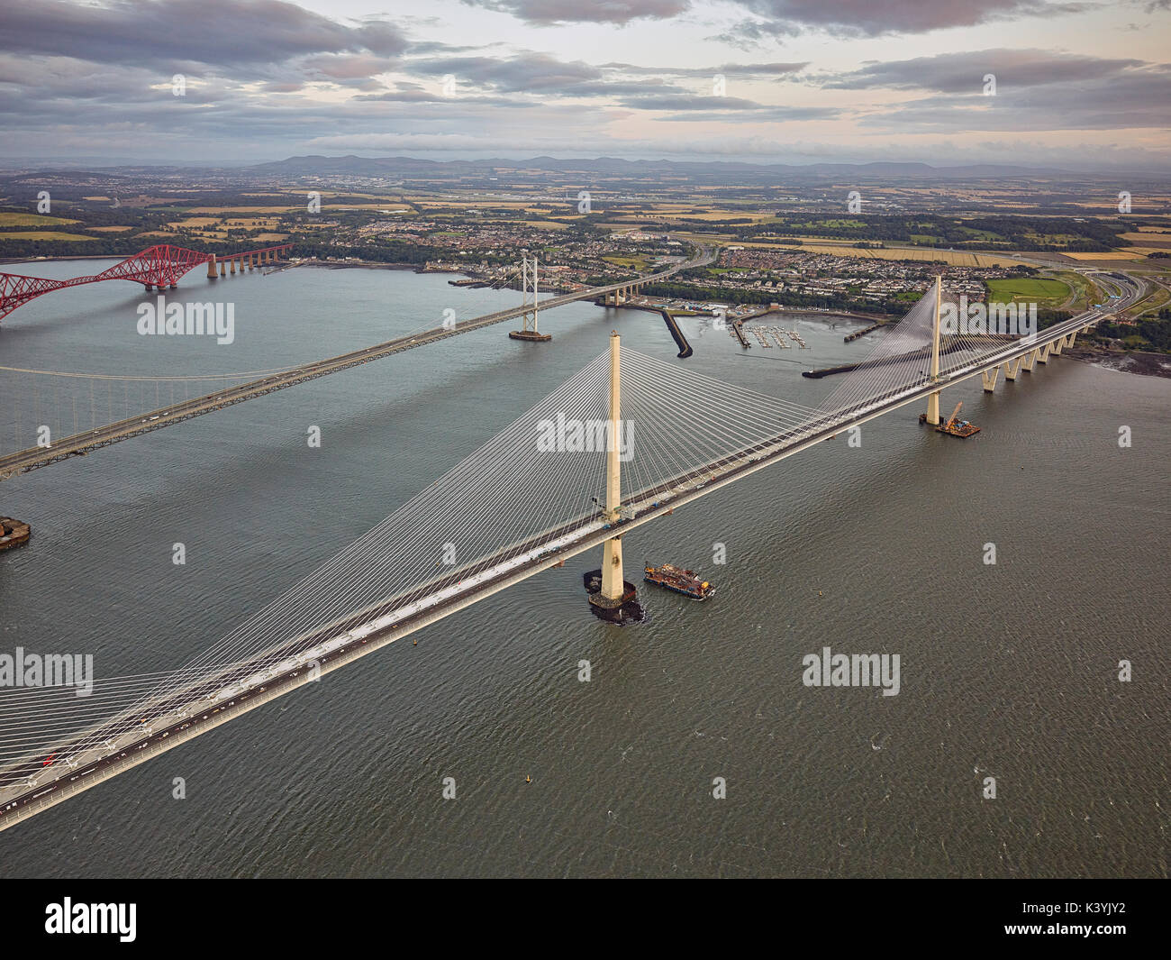 The three Forth Bridges, each built in a different century as seen from the air shortly before the latest addition, the Queensferry Crossing, opens to Stock Photo