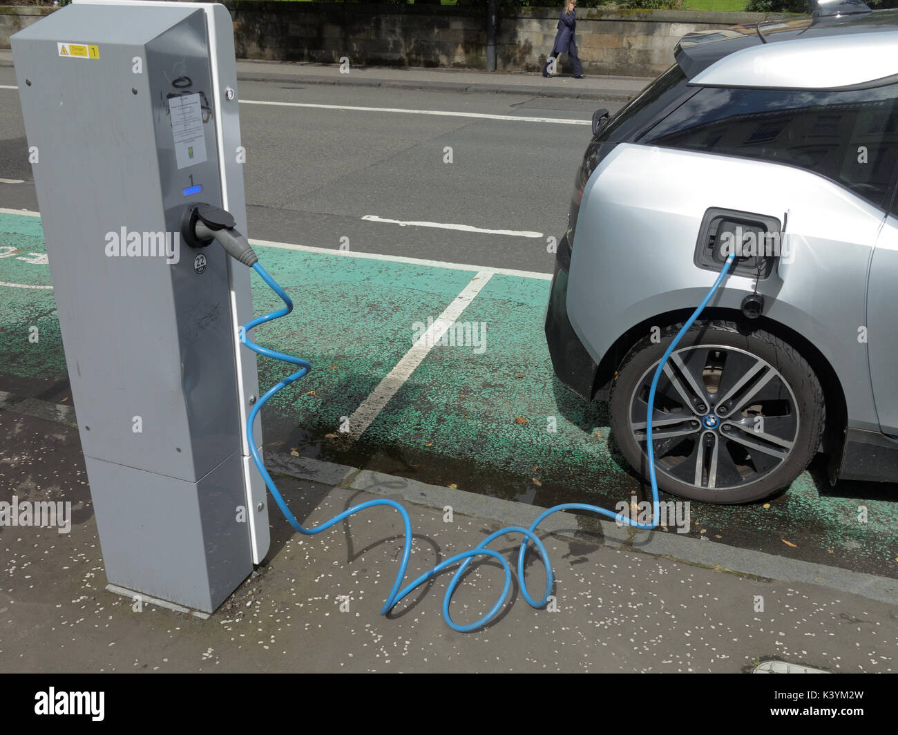 car being charged connected electric car charger point with symbols and signs Siemens electric vehicle charger Glasgow Stock Photo