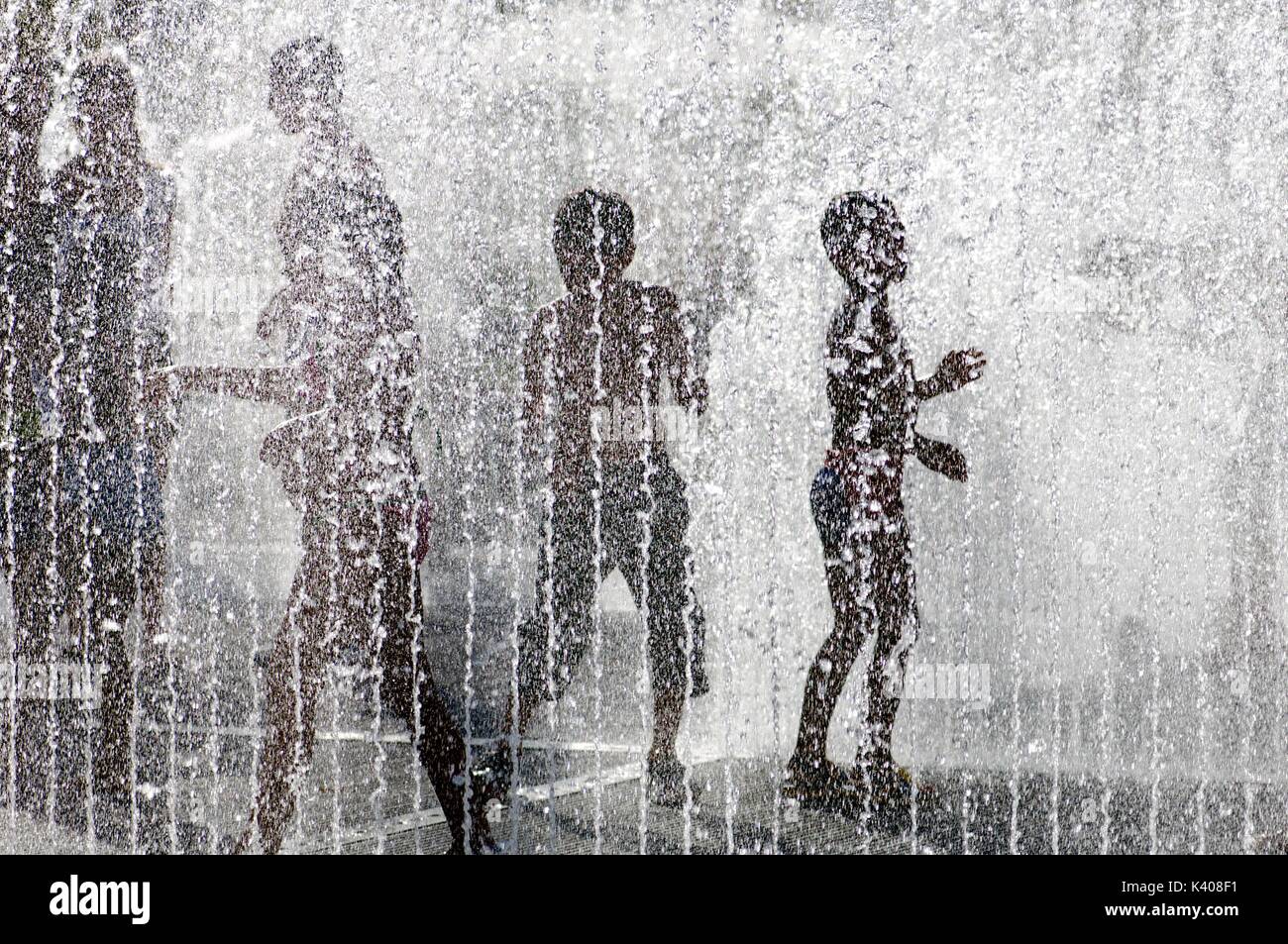 silhouette of a group of children playing in a water fountain Stock ...