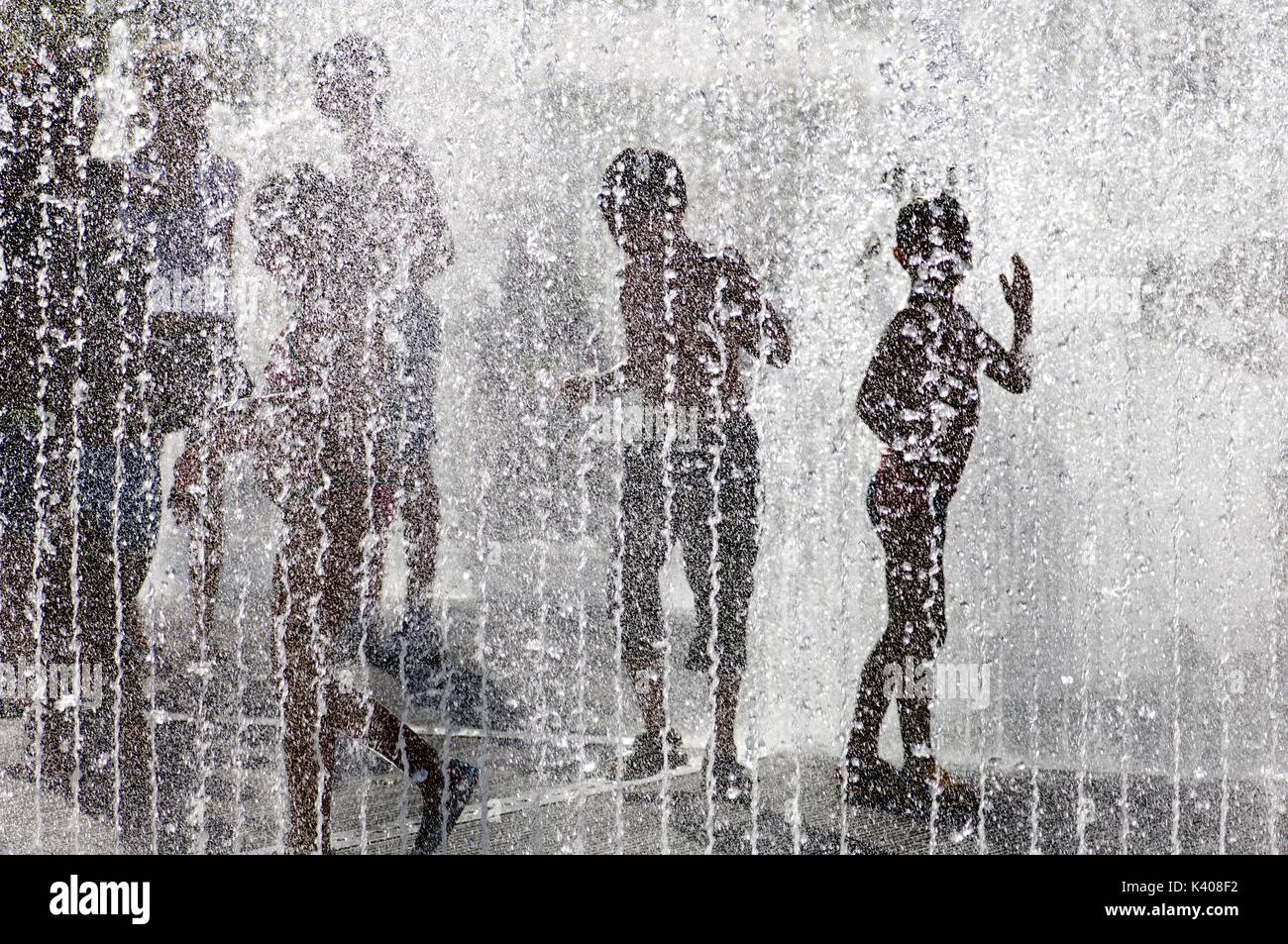 silhouette of a group of children playing in a water fountain Stock ...