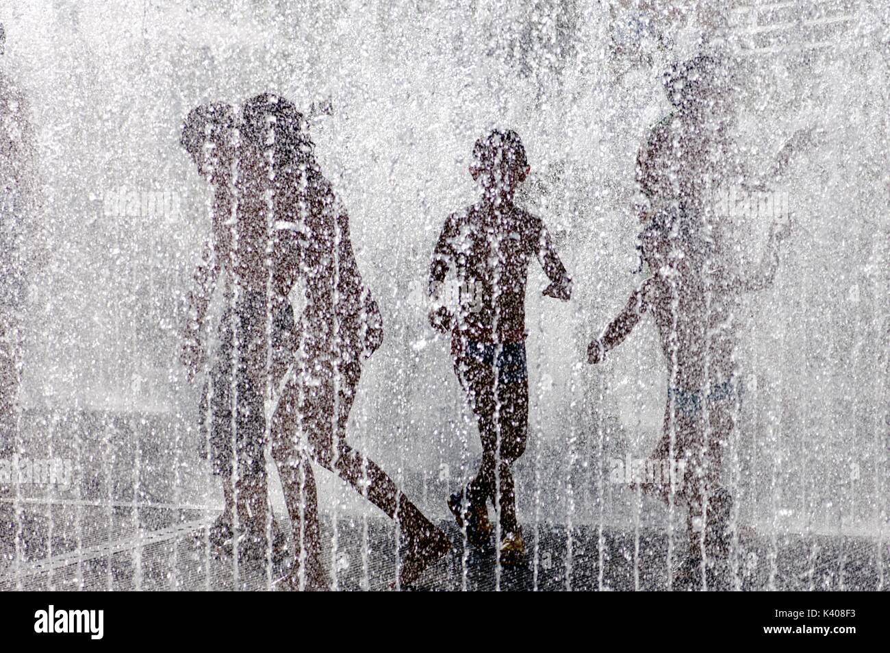 silhouette of a group of children playing in a water fountain Stock ...