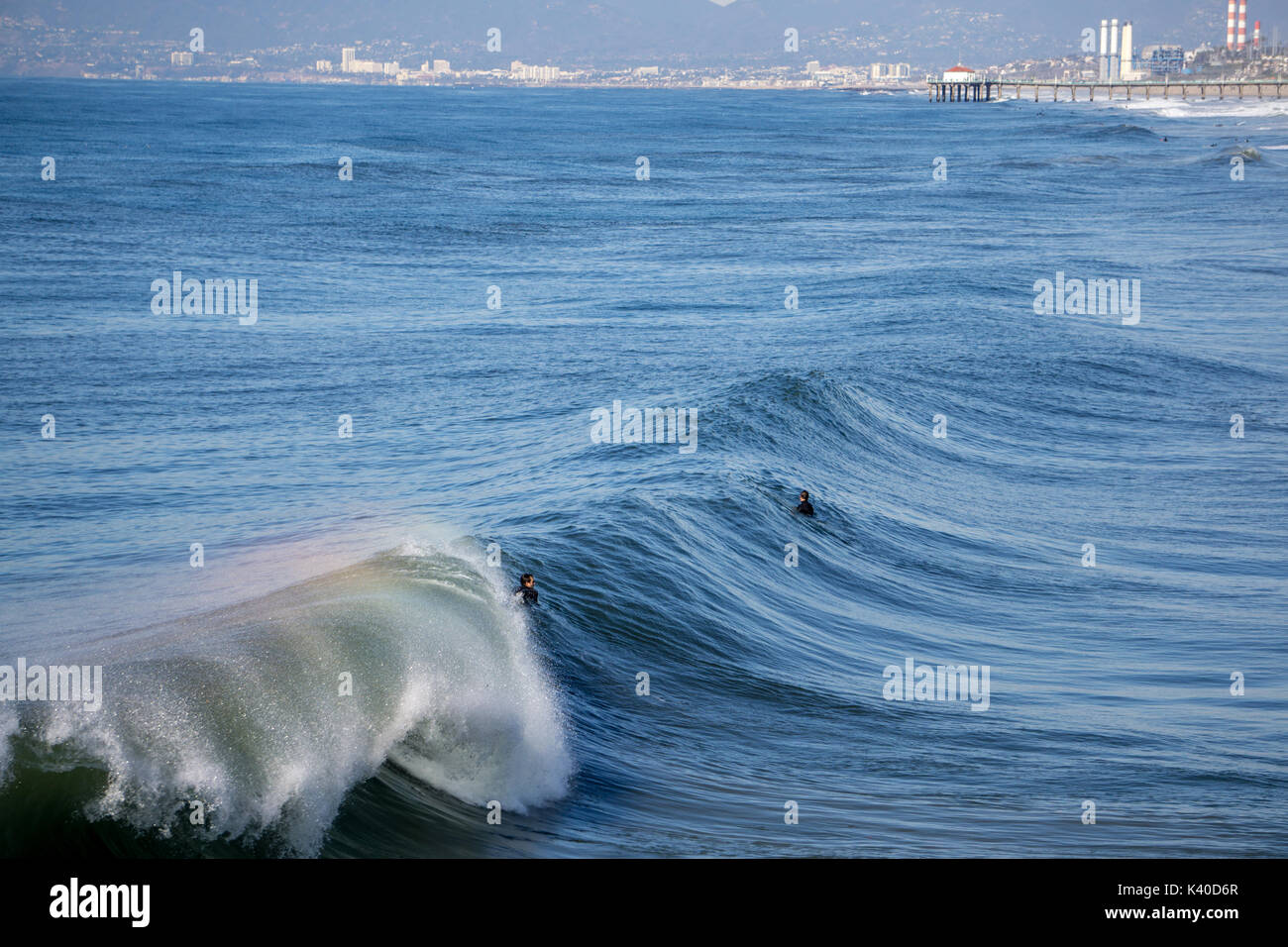 From atop the Hermosa Beach Pier, two surfers wait for the perfect wave Stock Photo Alamy
