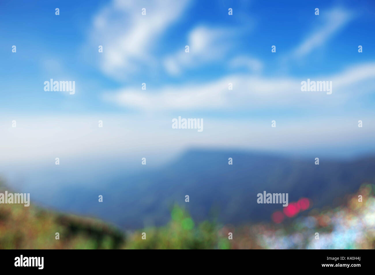Grass and mountains at blue sky with blurred images. Stock Photo